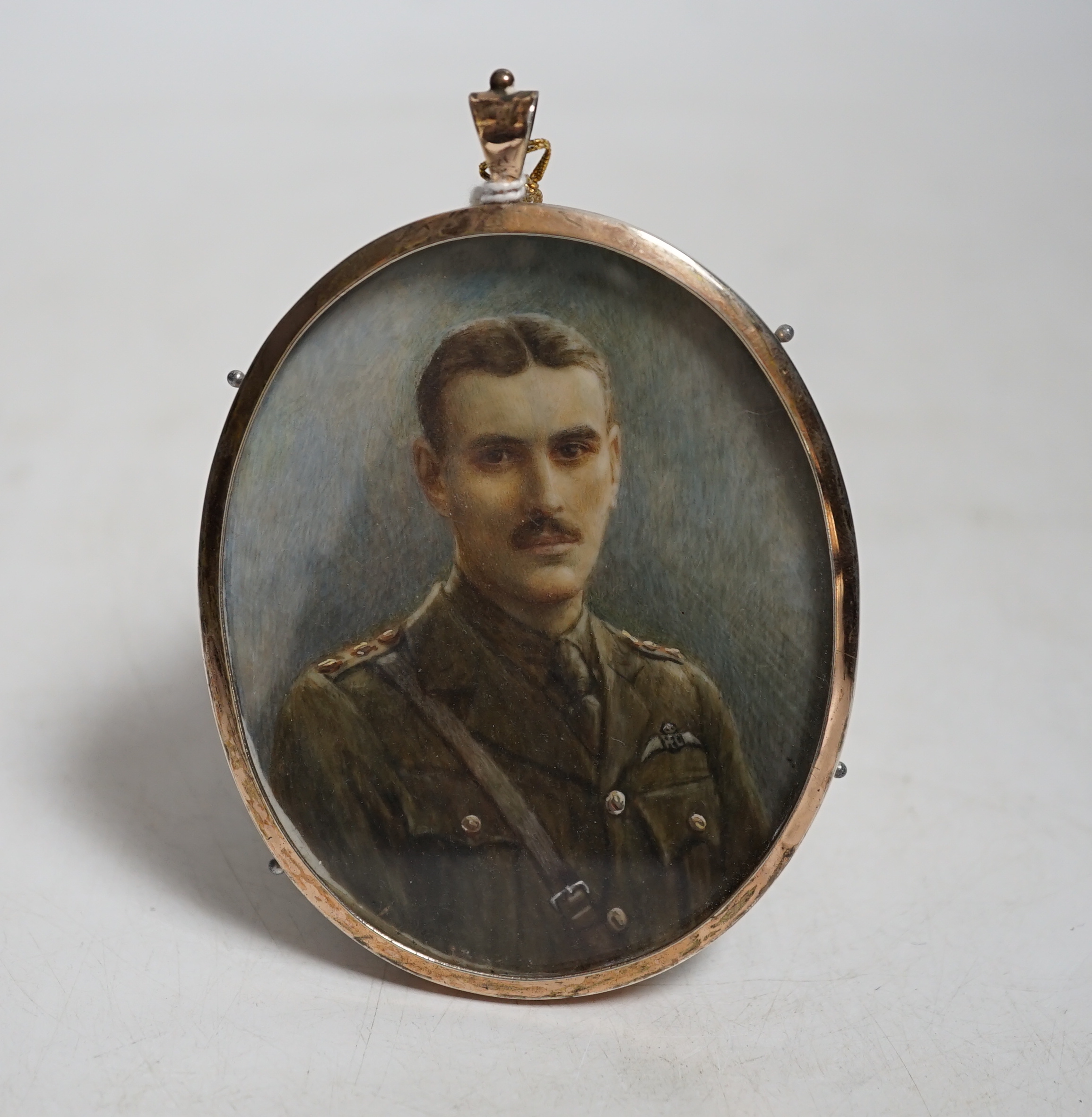 Miniature watercolour portrait on ivory of RFC officer Tom Abbot wearing military dress, with photograph of the sitter CITES Submission reference TPFS3A7Q